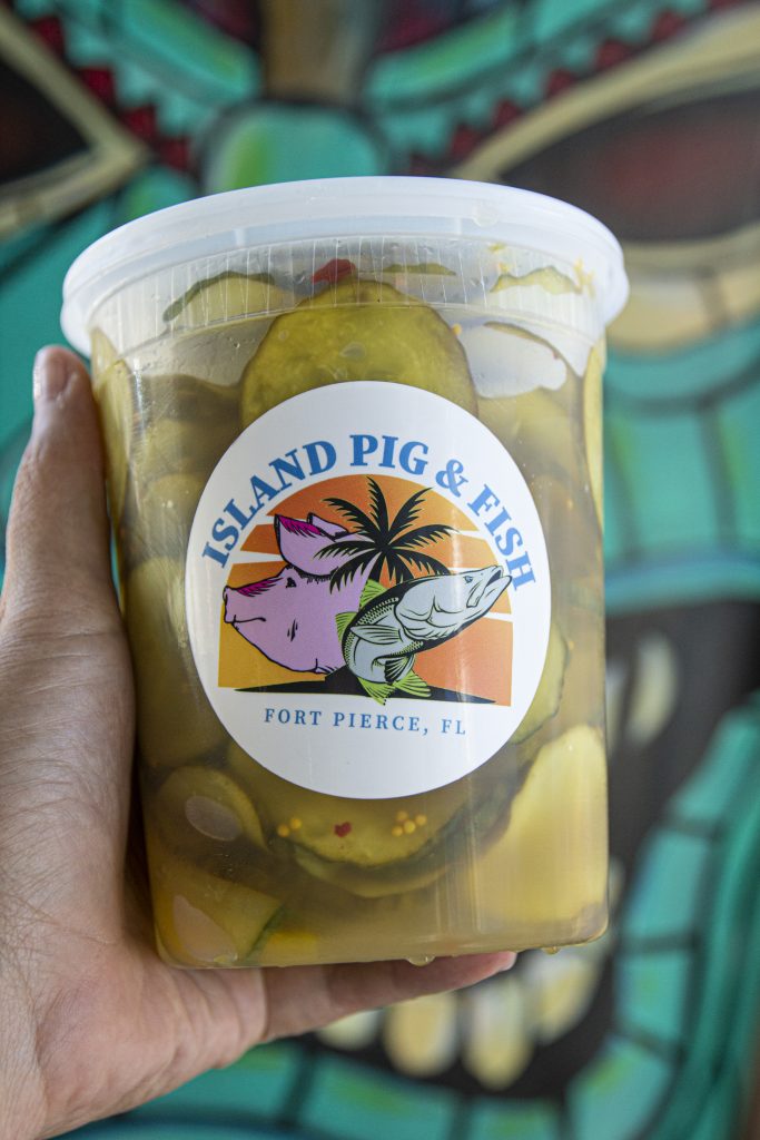 a jar of home made pickles with a sticker and logo on it